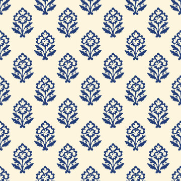 Indian block print seamless pattern with small ikat floral motifs arranged in neat grid on warm cream background traditional hand carved woodblock textile design.