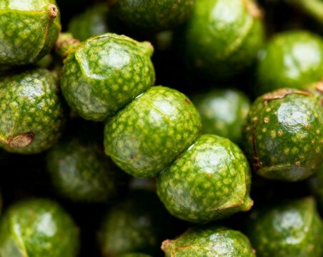 Close-up of vibrant green juniper berries and peppercorns with speckled texture