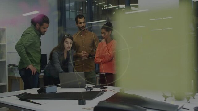Project team gathering around laptop and drones, yellow overlay clearing spurring tech design talk