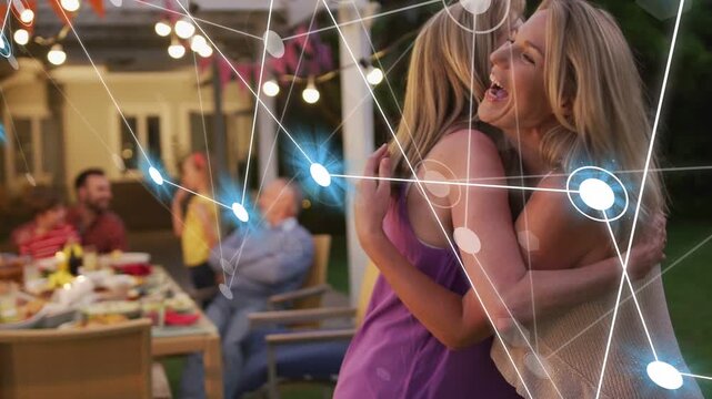 Two women calling out, stepping on dusk patio, greeting guests, embracing with tech nodes growing