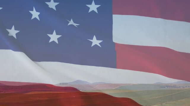Translucent US flag overlaying rural fields, frame start causing stars and stripes rippling for ads