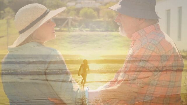 Senior couple gazing on porch, man putting arm around as surfboard overlay crossing couple for ads
