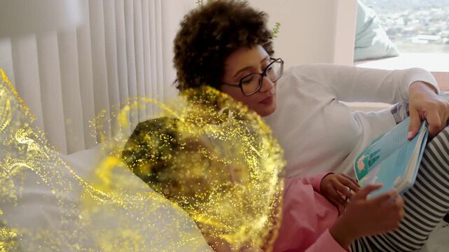 Mom guiding child reading book on bed, left golden spark starting and drifting around them learning