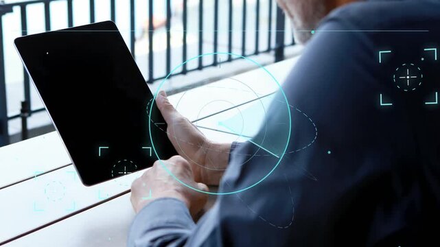 Mature man tapping smartphone and activating teal HUD graphics over hands and tablet for tech demo