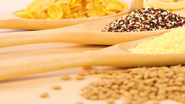 Gluten free cereal and legumes assortment on wooden spoons close up.