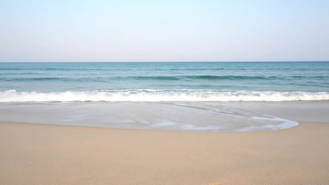 Serene ocean waves gently lapping on sandy beach in slow motion, creating a soothing seamless loop, symbolizing tranquility and relaxation.