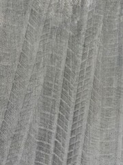 Obraz premium Tire Tread Marks Imprinted on Gray Concrete Surface Urban Pattern Background