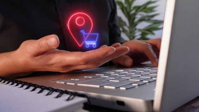 Location-based shopping services. Close-up of a businesswoman's hands working on her laptop while holding a virtual location pin icon and a shopping cart.