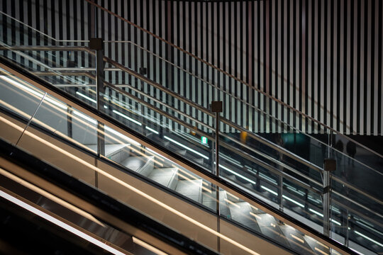 Glass and steel escalator near Shibuya Crossing in Tokyo, Japan.