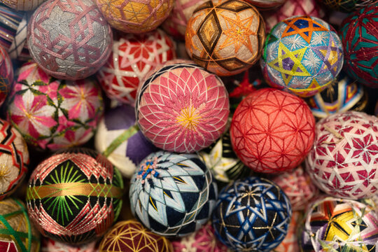 A colorful abundance of handcrafted temari balls; traditional Japanese embroidered thread spheres decorated with intricate geometric and floral patterns. Near Senso-ji Temple in Asakusa, Tokyo.