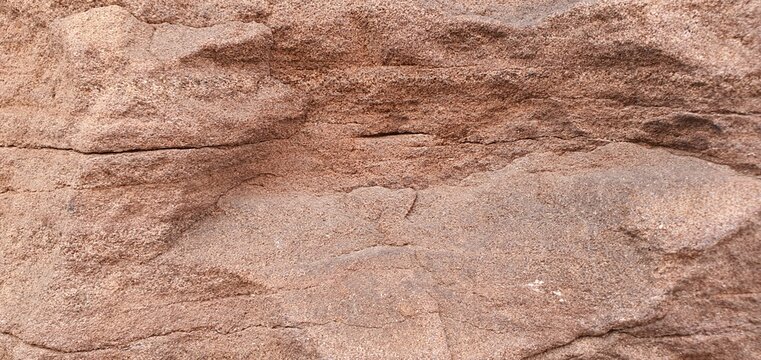 Abstract macro of scorched red mineral surface resembling Mars planet landscape. Gritty volcanic rock texture with deep craters, ideal for Sci-Fi and game environment