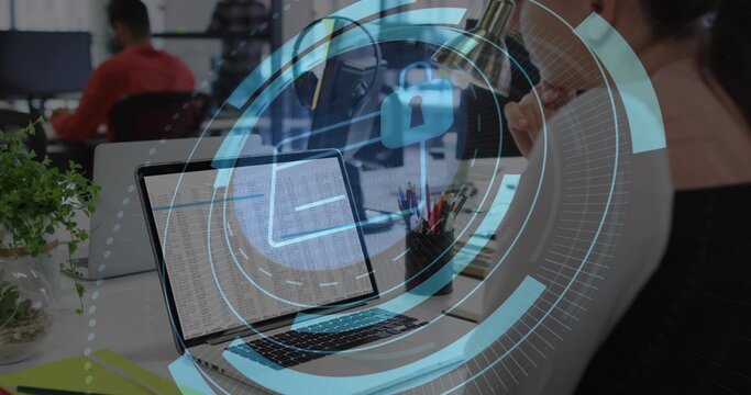 Leaning woman wearing light top examining data on laptop at office, HUD lock overlay visible