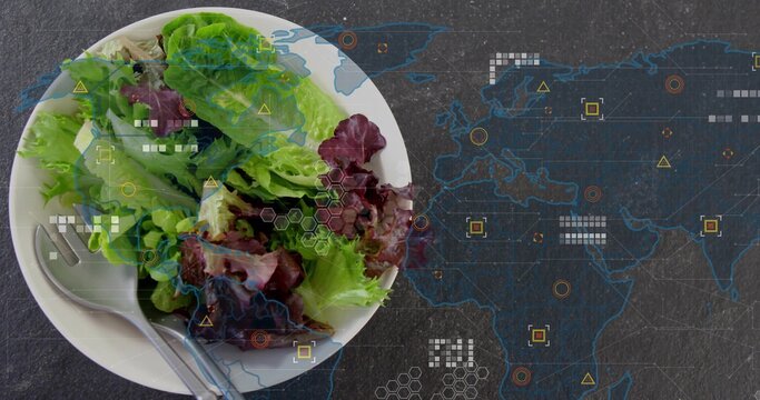 Showing white bowl of lettuce sitting left on slate table, utensils and map overlay, copy space
