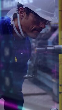 Vertical video: Shop tech leaning spotting light bringing hand to inspect and align metal shaft