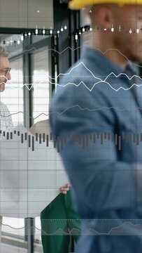 Vertical video: Designer with plan pointing as peer joining charts overlaying and crew passing cell