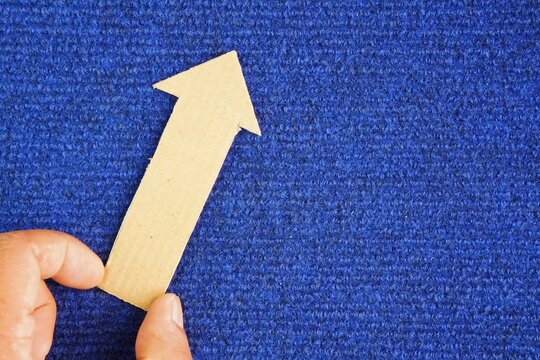 Hand hold an up arrow icon or symbol. Focusing on business growth trend, development opportunity or positive aspects. the concept of increasing or growing something
