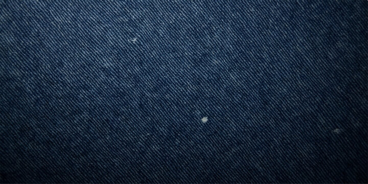 A dark blue denim fabric texture provides a rough cotton material pattern for a fashion clothing backdrop or wallpaper design