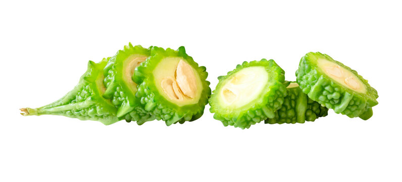 Side view of green bitter gourd or bitter melon in slices in circle shape in small pile isolated with clipping path in png file format