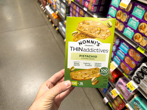 Nonnis Thinaddictives Pistachio Snack Crisps Box Held in Grocery Store Aisle