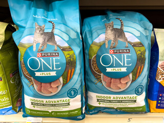 Fototapeta premium Purina One Plus Indoor Advantage Dry Cat Food Bags On Shelf