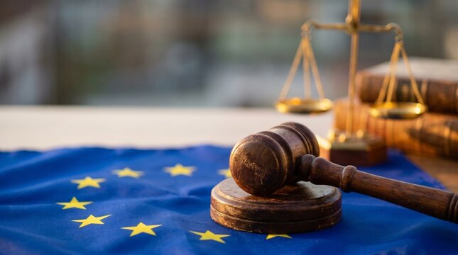 Justice scales and gavel on European Union flag, symbolizing law and legal proceedings
