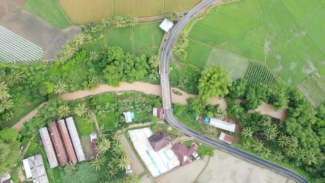 Aerial view using drone, river, highway and rice fields, in West Sumatra, Indonesia
