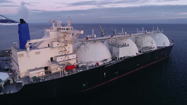 Aerial of Liquified Natural Gas LNG carrier moored to a small gas terminal. Fuel crisis. Sanctions