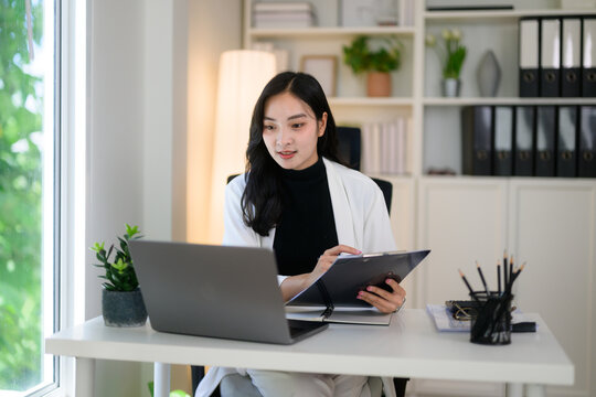 Young Asian woman joining virtual video meeting
