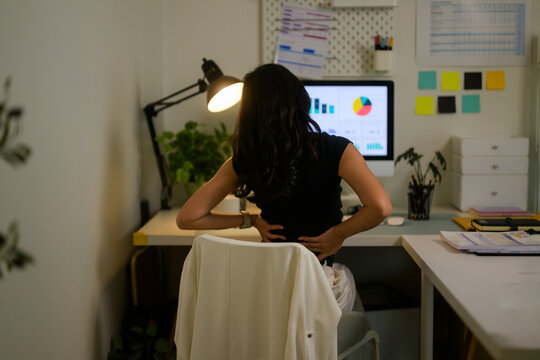 Woman feeling back pain working during long hours