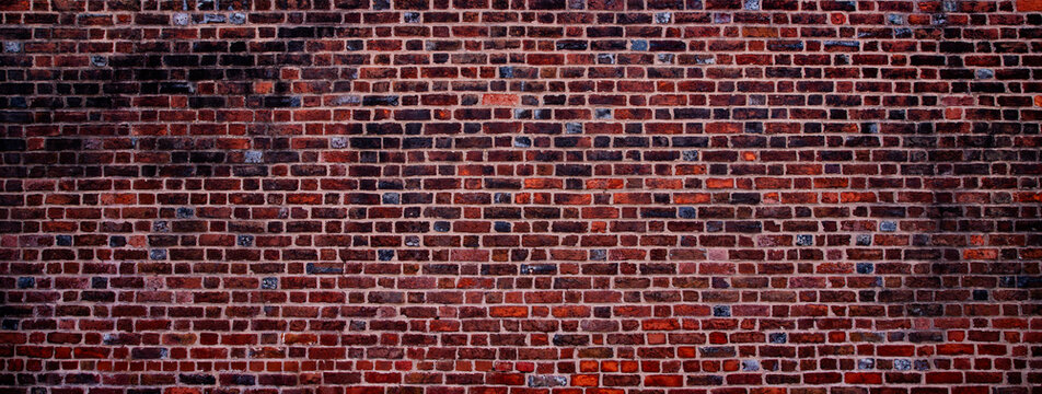 Red bricks wall background pattern. Vintage bricks brick wall texture surface. Rustic bricks masonry wall structure. Classic bricks mortar texture.