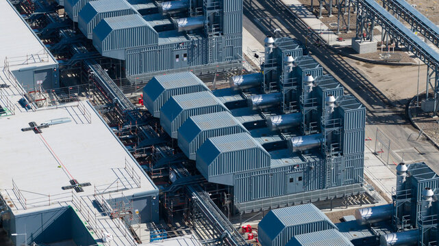 Aerial view of Datacenter Westpoort showing industrial cooling units, complex piping systems, and modern infrastructure in Groningen, Groningen, Netherlands.