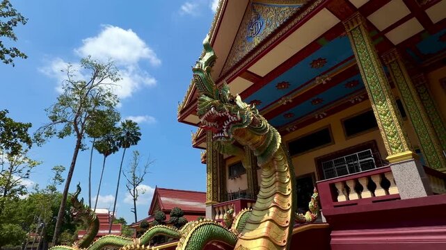  Magnificent Naga sculpture guarding the entrance of Wat Bang Thong temple in Krabi, Thailand. Detailed traditional Thai art and Buddhist mythology symbols in a majestic landmark.