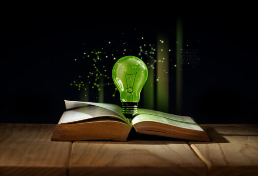 Light bulb glowing above open book representing creative thinking, innovation idea