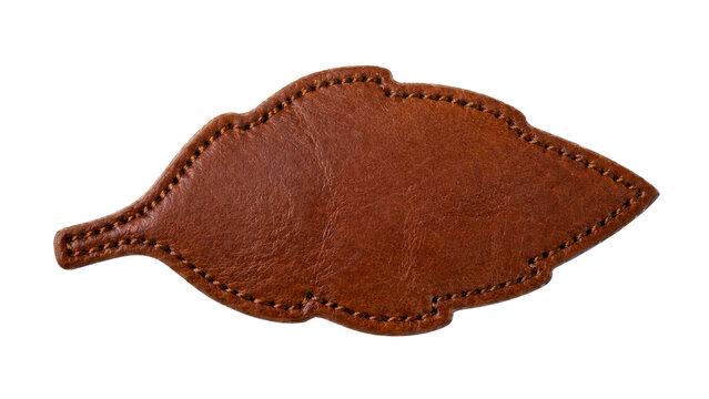 Stitched brown leaf shaped leather craft piece with natural texture isolated on transparent white background