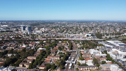 Fototapeta premium Aerial view of suburbs commercial district and train station