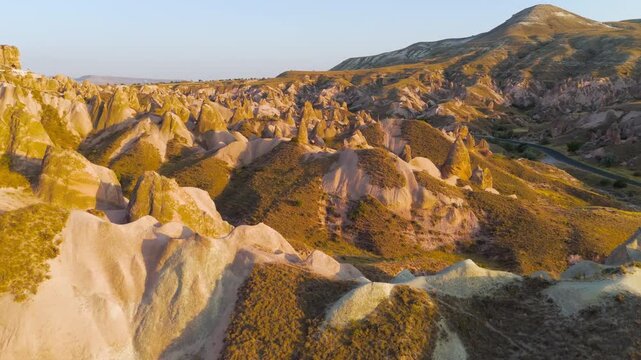 Goreme, Nevsehir, Turkey. Evening drone view of Devrent Valley surreal rock sculptures and fantasy-like formations in warm sunset light.. Aerial View