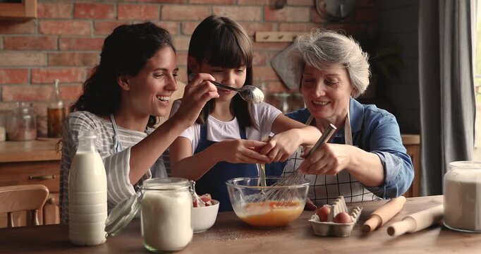 Happy intergenerational women with child enjoying time together at home, smiling, cooking pancakes for breakfast, baking in kitchen, preparing ingredients for homemade meal. Family bonding, culinary