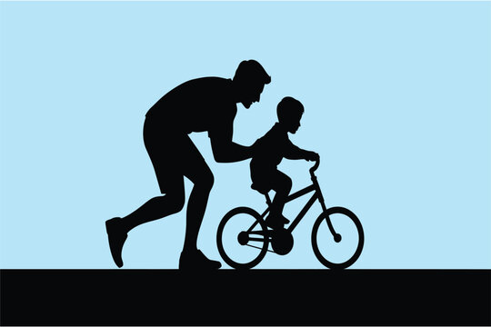Silhouette of a father teaching his son to ride a bicycle