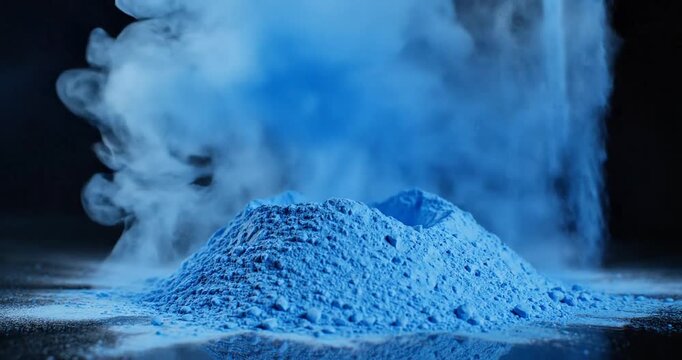 Hand Touching Blue Powder with Smoke Effect.
