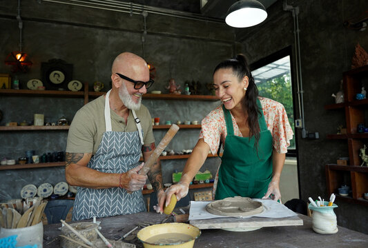 A happy couple makes ceramic plates in a workshop