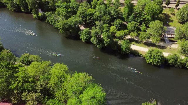 Aerial view of kayakers training on a river in summer