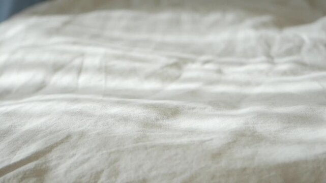 Soft light shines on bed sheets during morning hours
