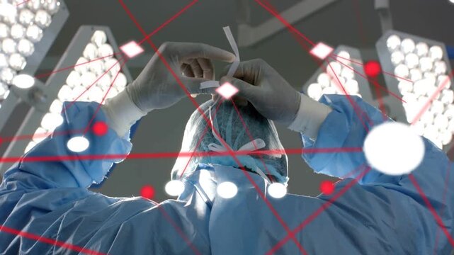 Vertical video: Surgeon tying cap and mask ties preparing for procedure, animated nodes mapping fit