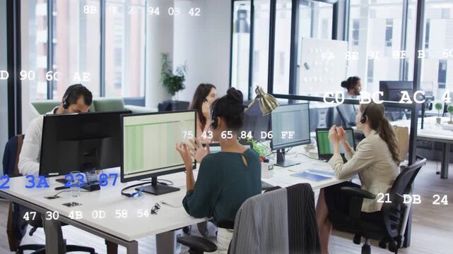 Office team wearing headsets taking calls, gesturing and typing while data codes overlaying desks