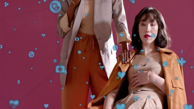 Models posing on pink backdrop, blue icons drifting, standing model placing gloved hand for fashion