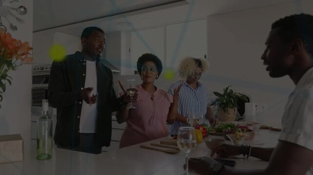 Host raising wine glass and speaking, group chopping vegetables and arranging salad for food prep