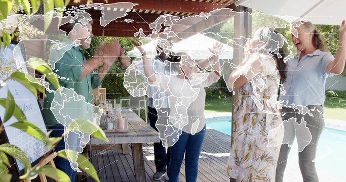 Clapping family gathering under pergola on deck, around picnic table in casual clothes, map overlay
