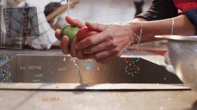 Mature woman turning on faucet and rinsing three round fruits at kitchen sink, removing debris