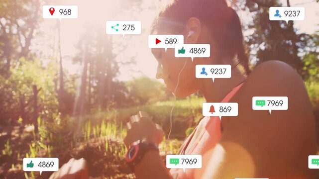 Woman adjusting earphones, tapping watch and warming up, causing fitness alerts drifting on trail