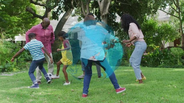 Family playing soccer for fun, boy nudging ball, adults blocking, blue globe appearing over group